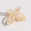 Detailed view of butterfly hair claw clip with pink marble pattern on yellow base - Pink Yellow