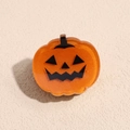 Detail of translucent orange resin pumpkin hair clip with festive glitter and Jack-o'-lantern face - Pumpkin