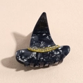 Macro detail of acetate witch hat hair claw with marble texture and sparkling rhinestones - Black Witch Hat