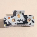 Detail of Halloween hair claw clip featuring pumpkins and bats on a rectangular acrylic base - White Bat Skull