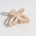 Close-up of a cream butterfly hair claw clip with a hollow resin wing design - Off-white