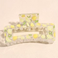Detail of square transparent hair claw clip featuring yellow lemon patterns and green leaves - Lemon Print