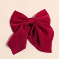 Dettaglio di un elegante fiocco in raso rosso scuro con nastri e texture liscia - Rosso