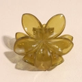 Detail view of flower hair claw clip in amber green resin with polished petal texture - Jelly Yellow Green