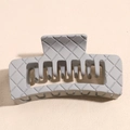 Detail of grey square hair claw clip featuring classic woven lattice texture and matte finish - Gray