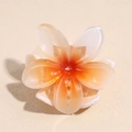 Detailed view of translucent resin plumeria flower hair claw clip with orange gradient - Orange Gradient