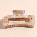 Close-up of square hollow hair claw clip with amber marble texture on beige surface - Beige