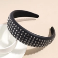 Detail of a wide black faux leather headband with five rows of silver metal rivets - Black