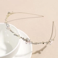 Primer plano de la diadema dorada con mariposas de esmalte, perlas y diamantes de imitación - Diseño de Mariposa