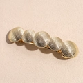 Close-up of golden alloy hair clip with five textured circular discs for a minimalist look - Gold Five Rounds Barrette