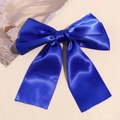 Detail shot of royal blue satin double-layered bow hair clip with long flowing streamers - Sapphire Blue