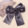 Detail of elegant dark grey satin double-layer bow hair clip on textured fabric - Dark Gray