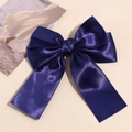 Detailed view of the smooth dark blue satin ribbon hair clip with double bow design - Navy Blue