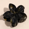 Elegant black frangipani hair claw with golden marble texture and glossy resin finish - Gradient Black Gold
