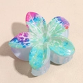 Macro shot of lily flower hair claw with colorful tie-dye patterns and glitter finish - Purple Grey