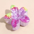 Close-up of a floral hair claw clip featuring tropical tie-dye patterns on ABS material - Purple Green