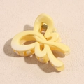 Macro detail of a yellow resin butterfly hair claw clip with a strong metal spring mechanism - Butterfly Yellow