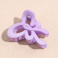 Macro shot of a matte lavender bow hair claw clip showing a purple metal spring - Butterfly Purple
