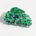 Macro detail of leaf-shaped acetate hair claw with colorful marble texture pattern - Dark Green Pink
