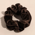 Close-up of dark coffee velvet hair scrunchie with shimmering glitter and wavy ruffles - Dark Brown