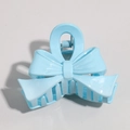 Macro view of a light blue bow-shaped hair clip made of glossy resin with metal spring - Blue Bowknot