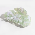 Detailed macro view of the monstera leaf hair claw with green marble acetate texture - Dazzling White Green