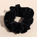 Close-up of black velvet scrunchie with subtle pearlescent finish and pleated texture - Black