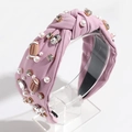 Detailed close-up of pink knot headband with pearl rhinestones and football charms - Lotus root pink