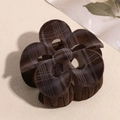 Close-up of brown flocked plaid frangipani hair claw clip with golden metal spring - Hollow Dark Brown Flower