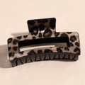 Detail of a rectangular leopard print hair claw clip with a glossy acrylic finish - Large Block Khaki Leopard