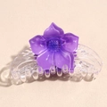 Detailed close-up of translucent purple flower hair claw clip with resin resin texture - Purple