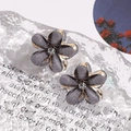 Close-up of grey-purple camellia stud earrings with rhinestones and gold-tone finish - Single Flower Style / 1 Pair Pack / Gray