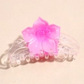 Detail view of transparent hair claw clip featuring a pink floral design and strong grip teeth - Rose Red