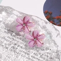 Close-up of translucent purple flower earrings with sparkling glitter and diamond center - Single Flower Style / 1 Pair Pack / Purple
