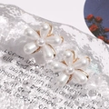 Close-up of elegant camellia flower earrings with white teardrop pearls on a textured background - Artificial Pearl Flower Style / 1 Pair Pack / White
