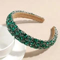 Macro detail of luxury baroque headband with emerald green rhinestones and velvet lining - Green