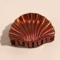 Detail view of red-brown shell hair claw with gold glitter finish and glossy resin texture - Small Orange Red