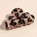 Close-up of leopard print acetate hair claw clip with unique wavy cloud-shaped edge design - Scalloped Beige