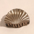 Macro detail of the bronze shell hair claw with metallic shell texture and strong teeth - Small Gold