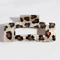 Detailed macro view of leopard print acetate hair claw clip with cream base and dark spots - Rectangular Khaki