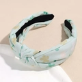 Detail view of the knotted mint green floral fabric headband with a non-slip lining - Light Cyan Clover