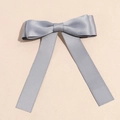 Detail of dark grey satin bow hair clip with elegant long ribbons on a beige background - Gray