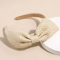 Detailed view of raffia bow headband showing textured weave and anti-slip lining - Beige