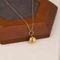 Polished 18K gold ball pendant necklace on a minimalist wooden display stand - Gold Round Ball Style (NE148)