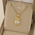 Elegant gold teddy bear pendant necklace with heart-shaped zircon on a jewelry box - White (NE299)