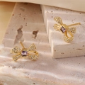 Eleganti orecchini a fiocco dorati con zircone viola e pavé di cristalli lucidi - Stile Fiocco (es11)