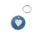 Detail showing blue glitter finish and silver heart design on round metal pet tag - 25mm / Dark Blue