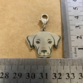 Detailed macro view showing a 3.5cm dog head shaped stainless steel tag with lobster clasp - Labrador Style