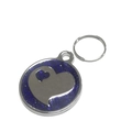 Macro view of a round blue glitter pet tag with silver heart charms and a key ring - 25mm / Blue