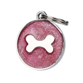Close-up of a round pink glittery dog ID tag with silver bone charm and metal ring - Red